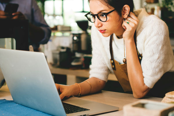 Coffee shop employer signing up for Secure Choice pilot on laptop
